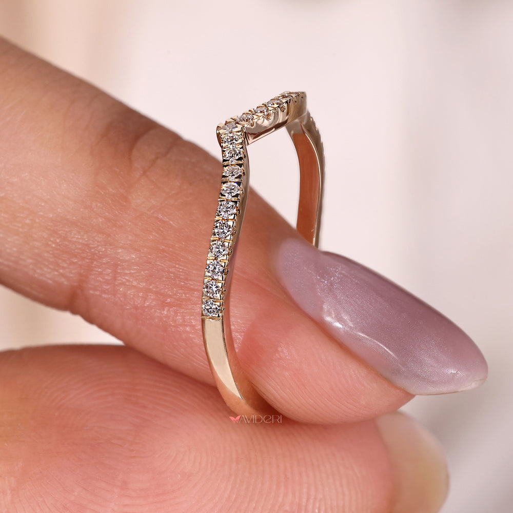 Round diamond wave eternity band in yellow gold, offering a modern and unique design.
