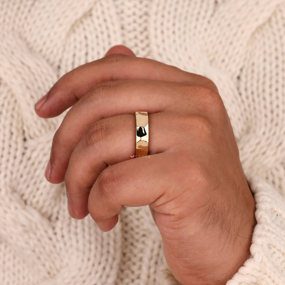 Handmade hammered wedding band with round cut diamond accents.
