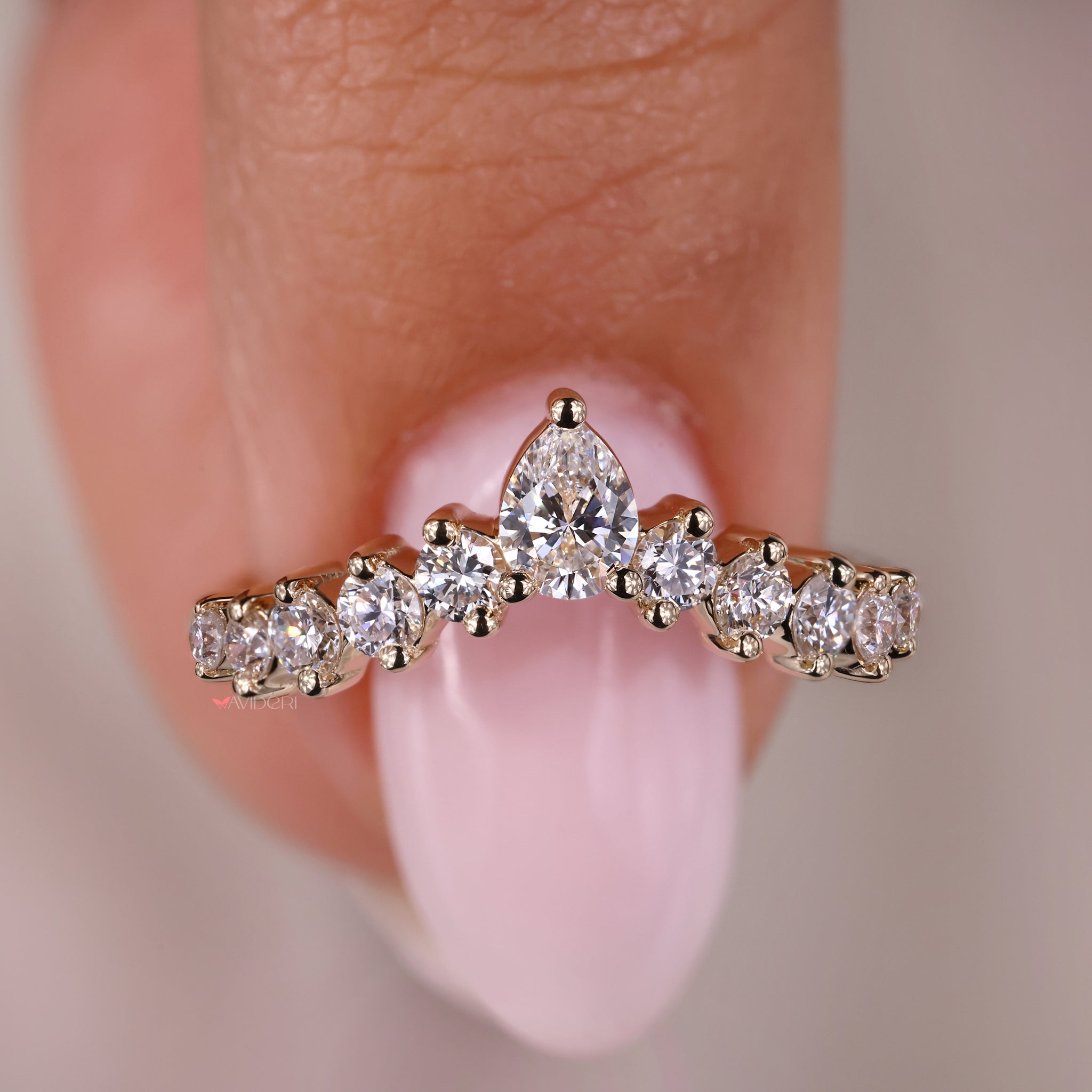 Wedding band for pear shaped ring with round diamond accents for beauty.
