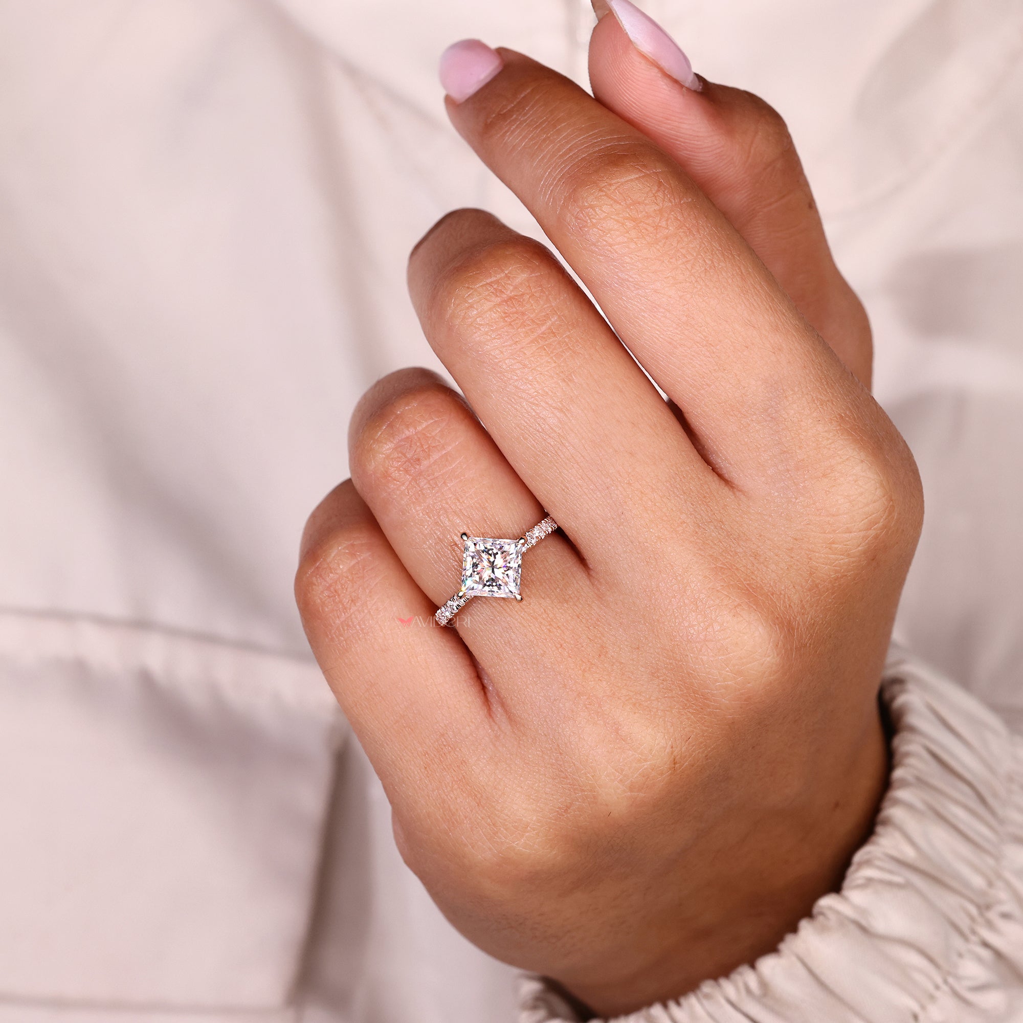 Classic princess cut engagement ring with compass prong and pave design in rose gold.