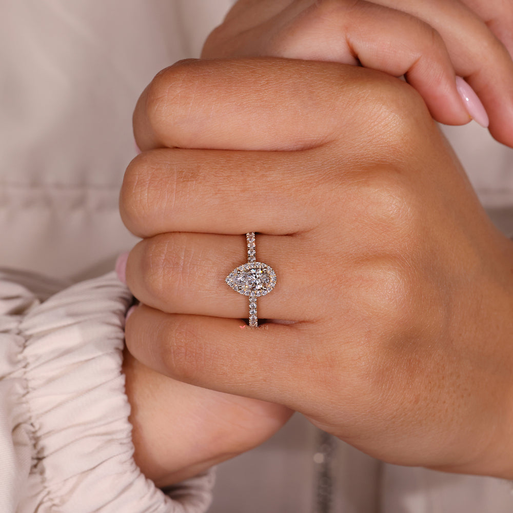 Round prong setting ring designed with pave diamond accents.
