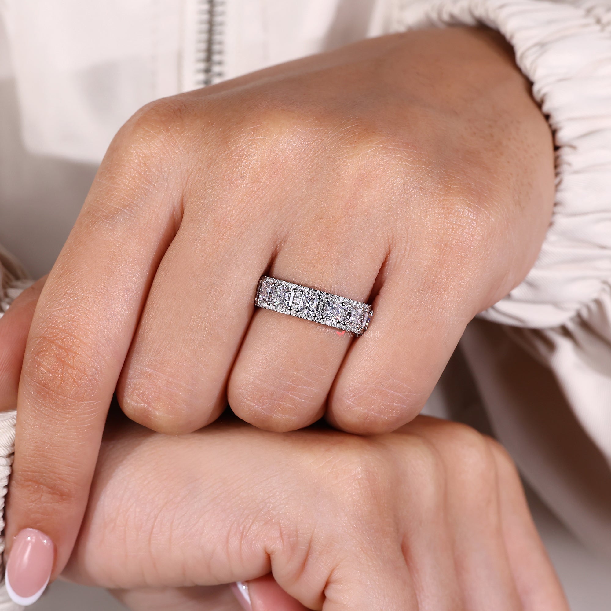 Round prong set Moissanite wedding band.