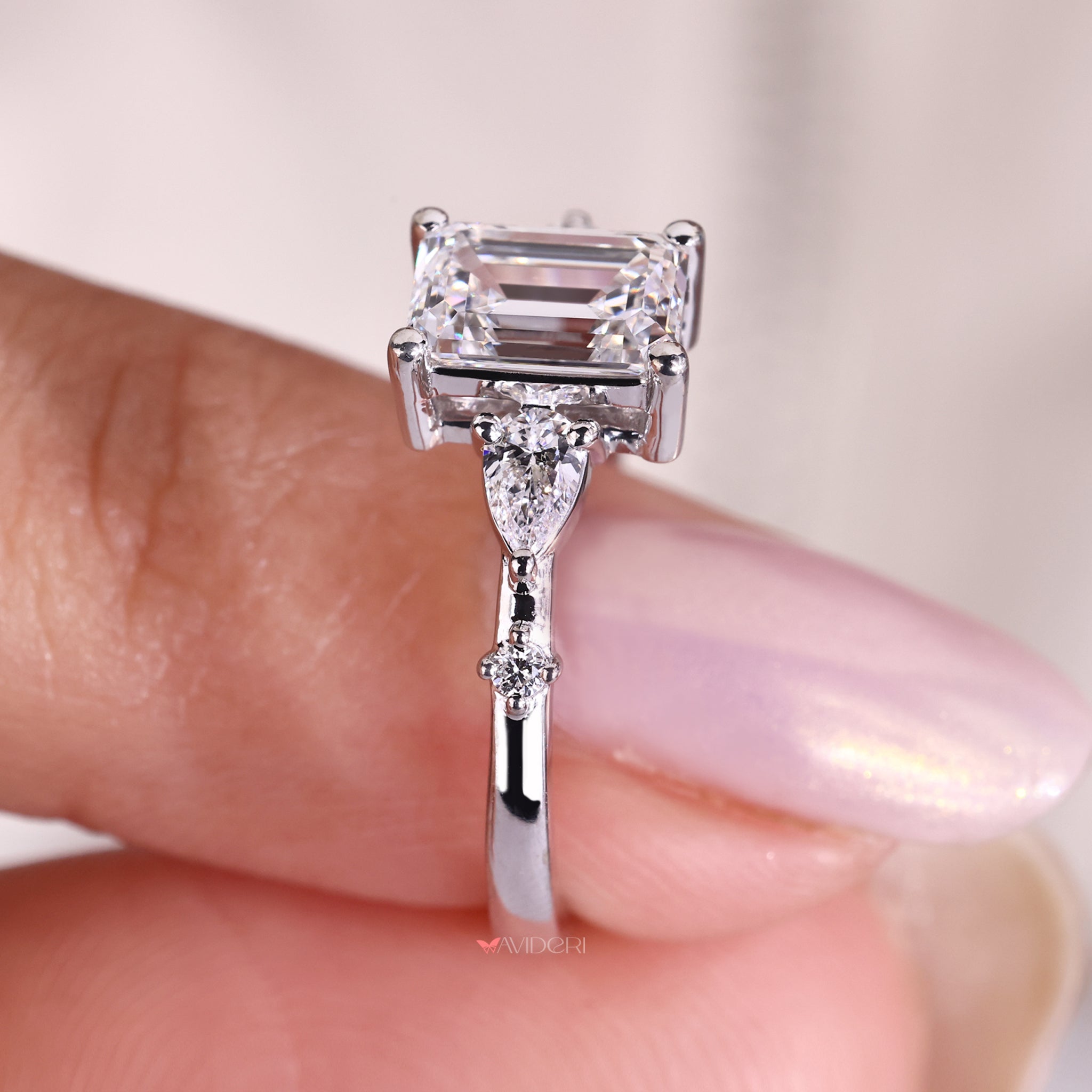 Emerald diamond ring designed as a five stone engagement ring with Lab Grown Diamond.
