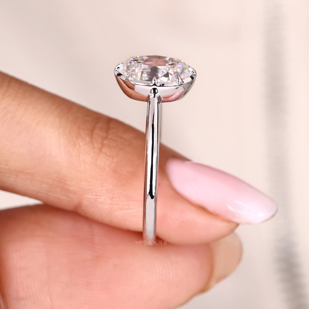 Vintage style oval solitaire diamond ring with bezel setting.