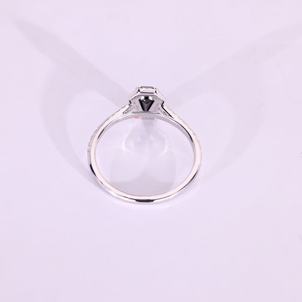 Coffin cut ring with pave halo and cathedral style.