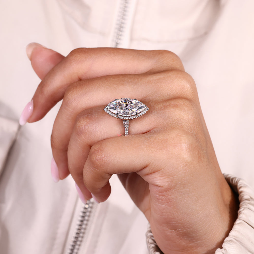 Marquise halo ring with round cut moissanite and pave band.