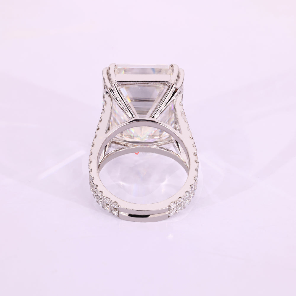 Cathedral setting emerald cut ring with pave shank.