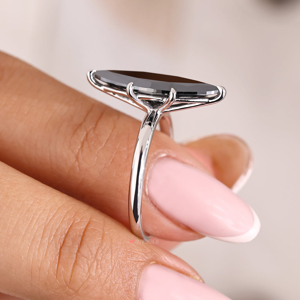 Moissanite engagement ring with a marquise cut center.