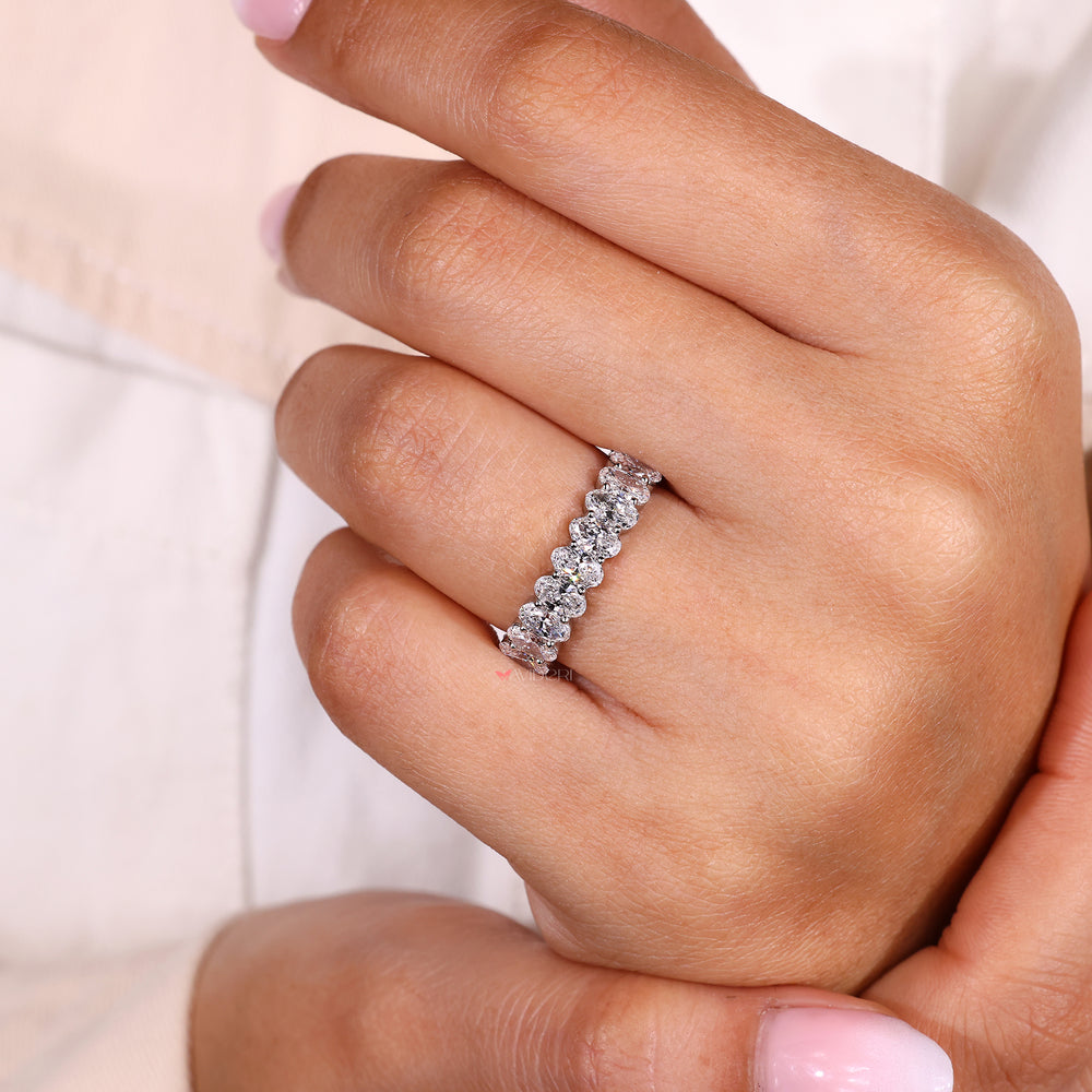 Buy a wedding band with oval stones.