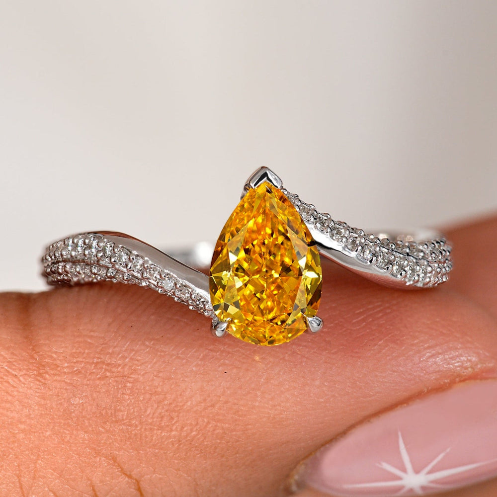 Elegant pear shaped engagement ring with a stunning diamond design.
