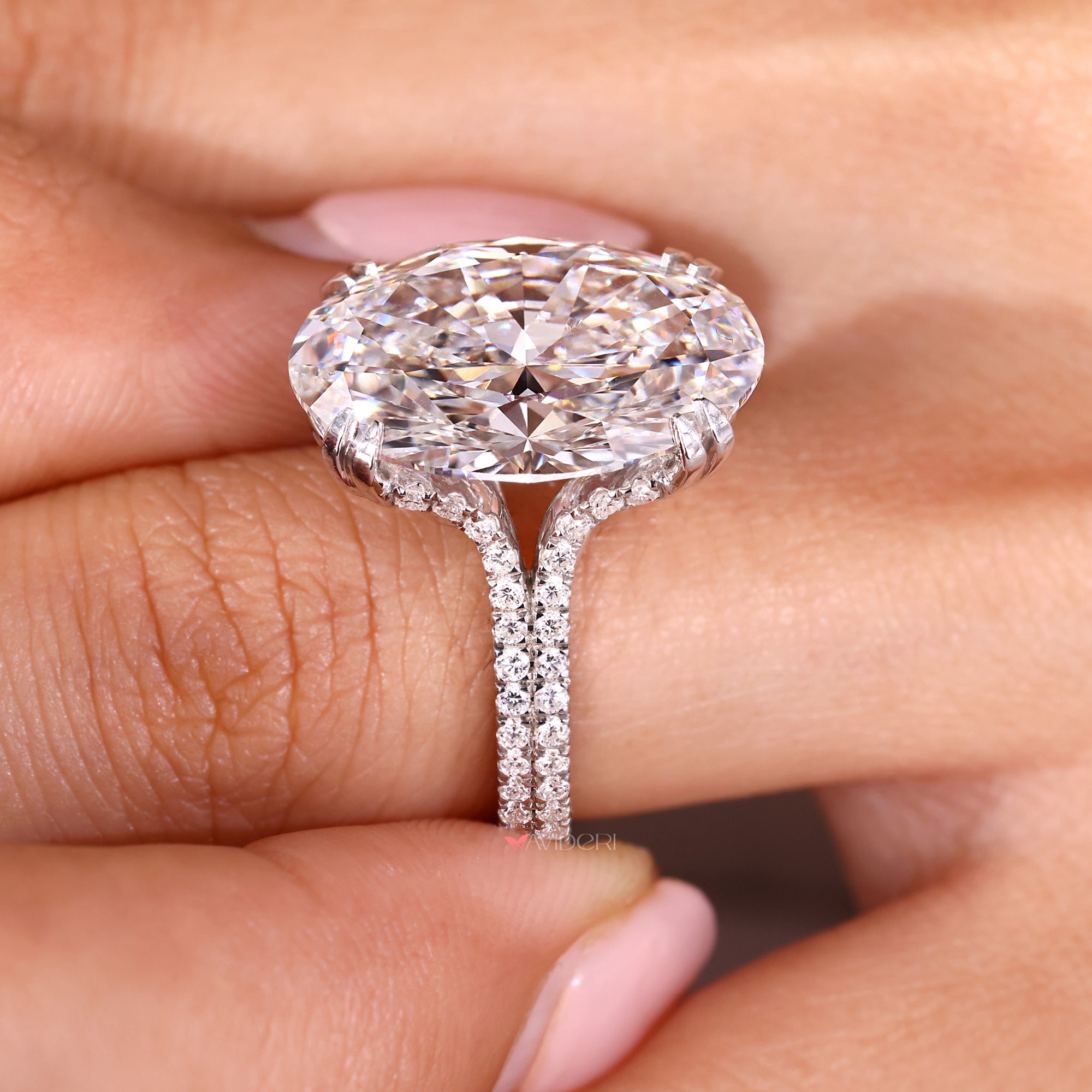 Oval diamond ring with round cut diamond double row pave band.
