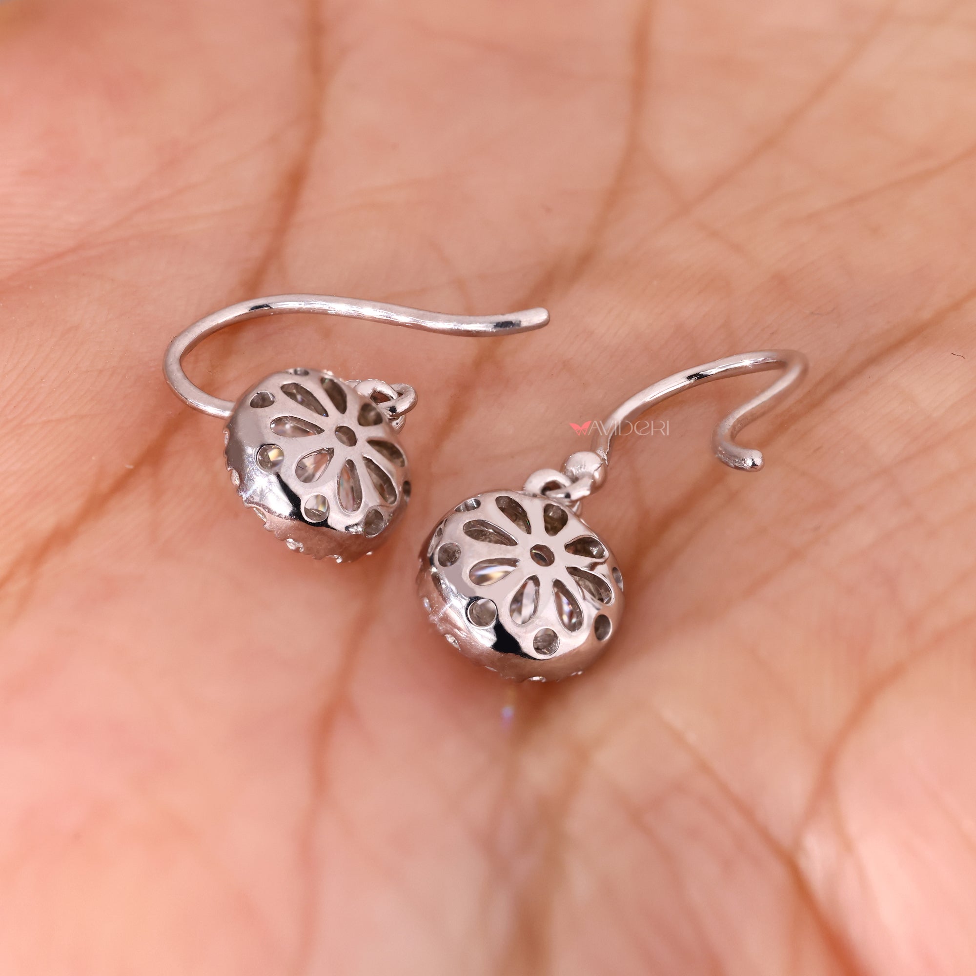 White gold earrings with delicate round diamond details.
