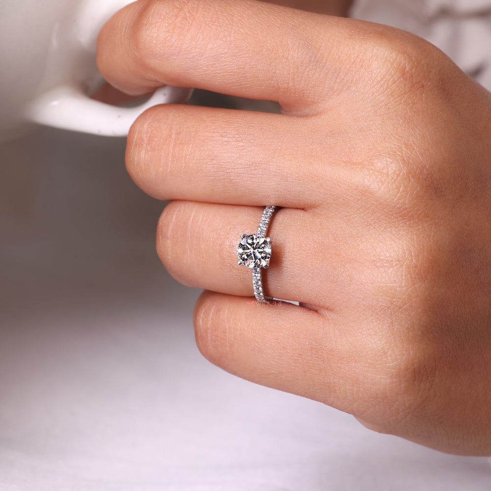 Round diamond ring with a pave band, designed for a clean and modern look.
