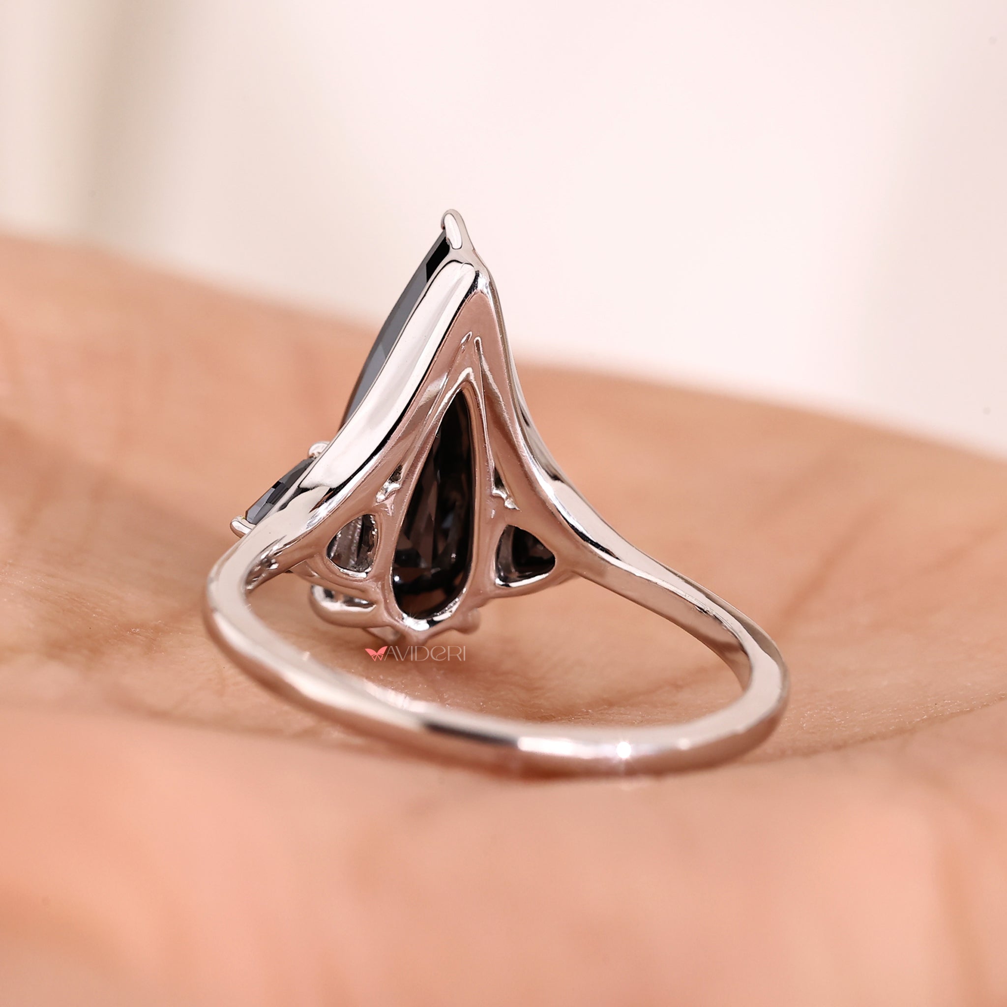 Handmade ring created with pear-cut moissanite and diamonds.