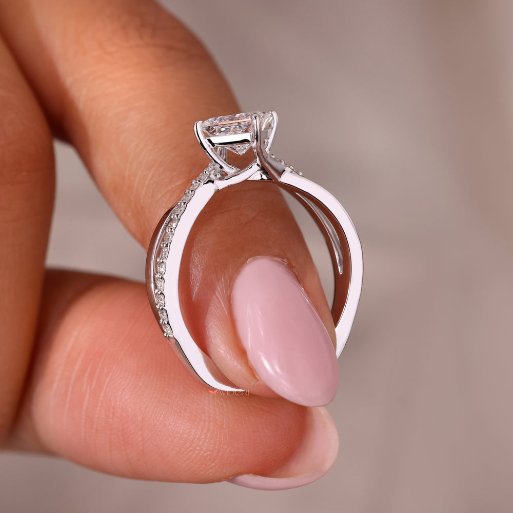 White gold engagement ring crafted as a twisted ring with elegant pave accents.

