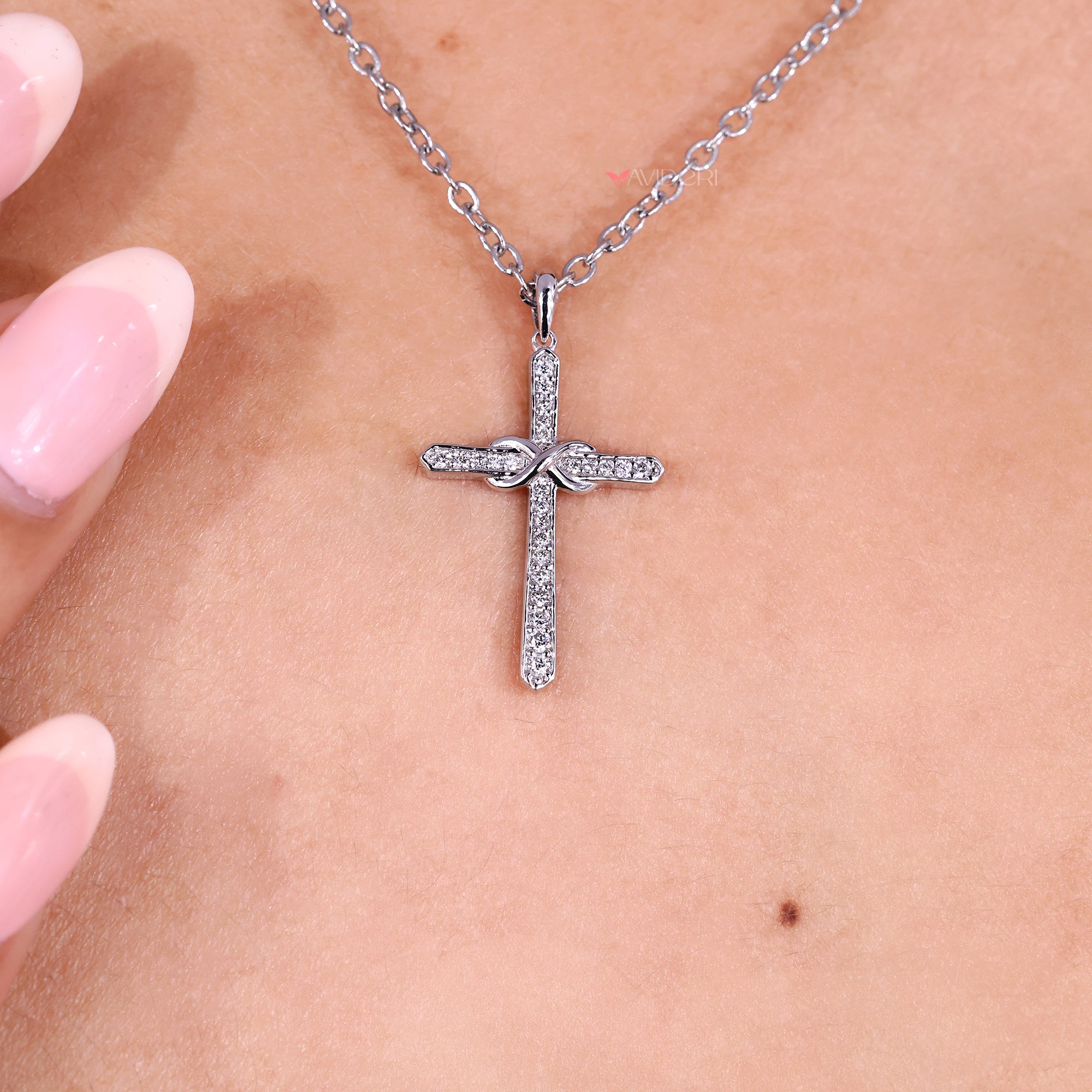 Infinite cross pendant with round diamond.
