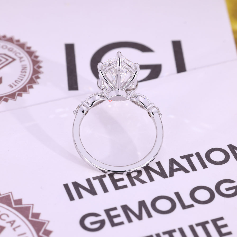 White gold ring with marquise cut and round side stones.