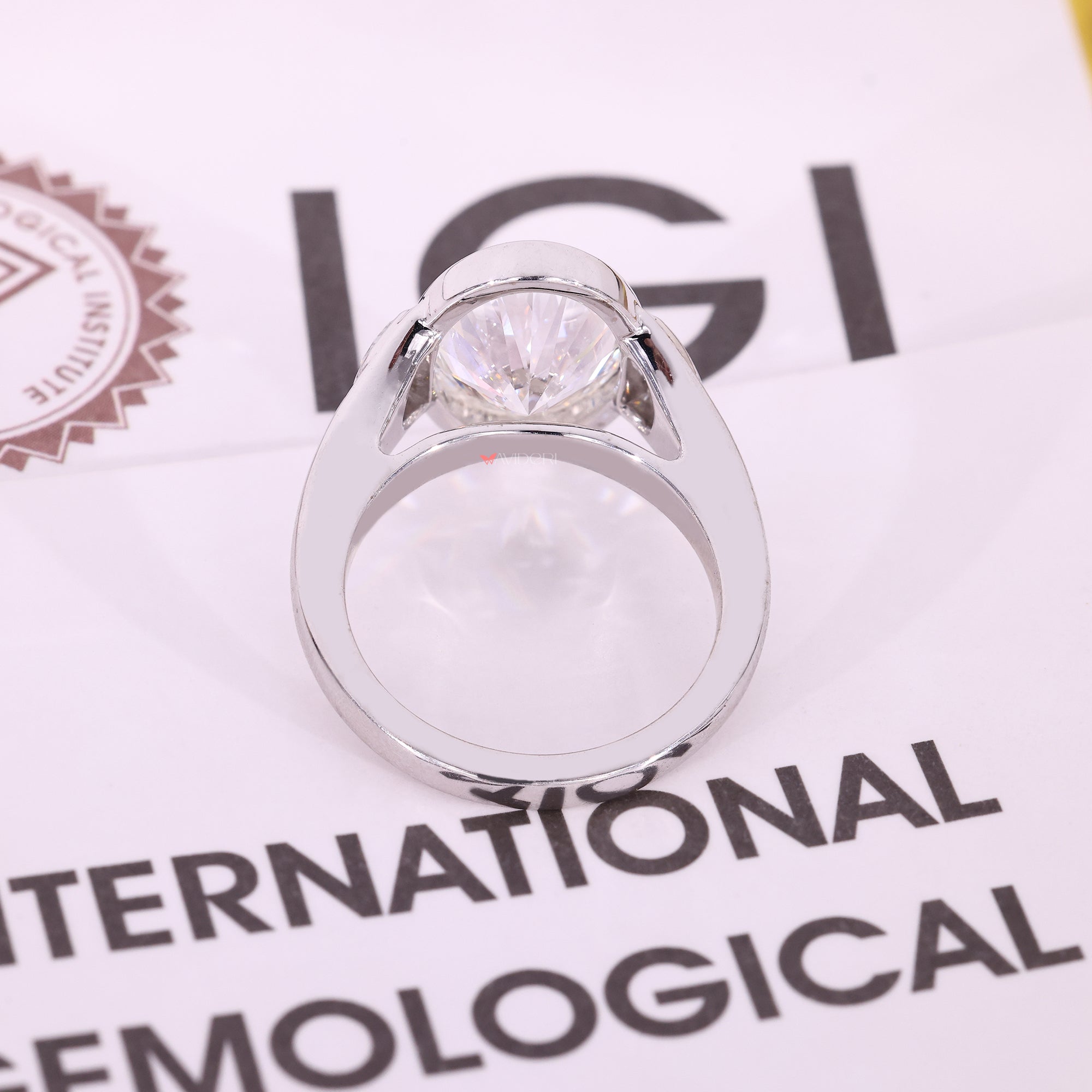 Oval cut diamond ring with half moon side stones.