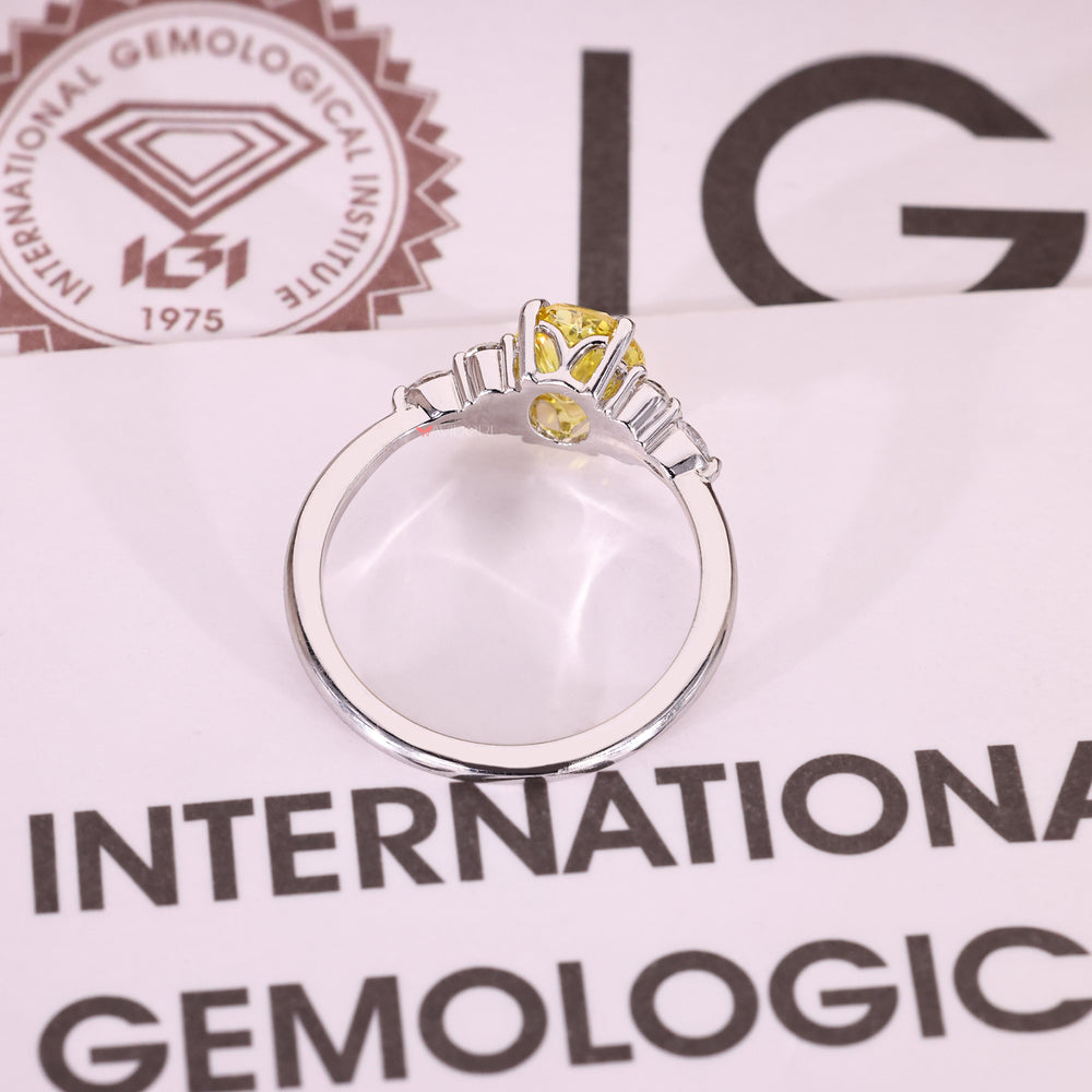 Oval yellow diamond ring with marquise accents.