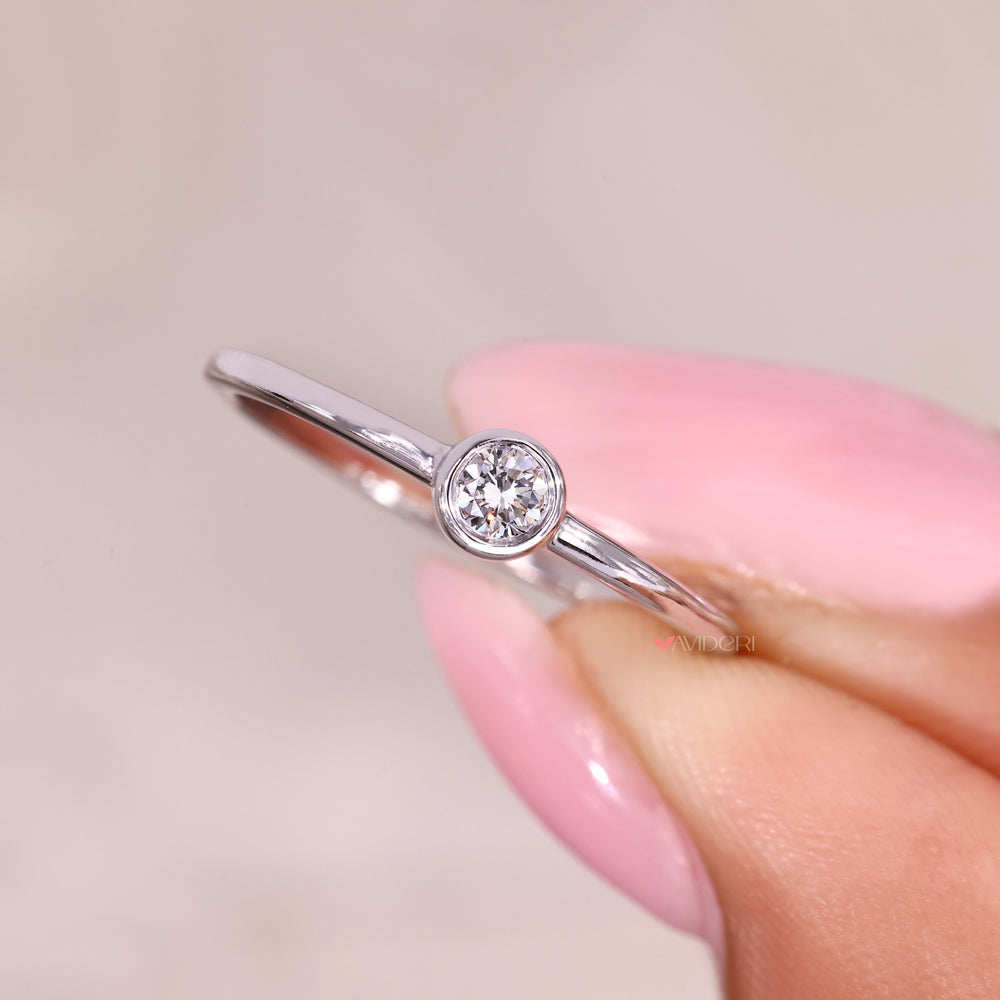 Bezel set round diamond ring with elegant profile.

