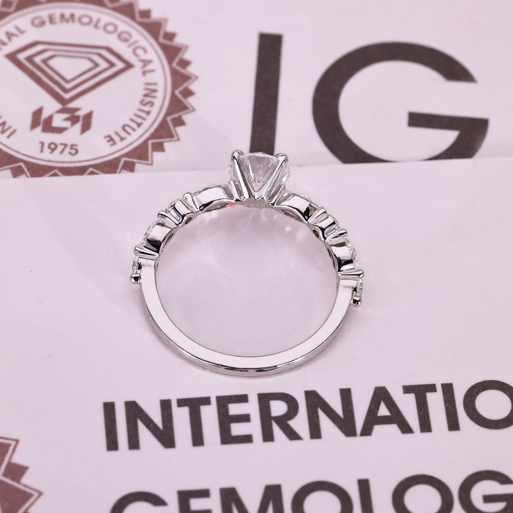 Round diamond ring with marquise and round accents.