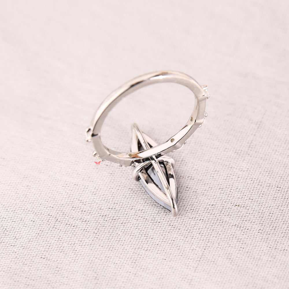 White gold ring with seven stones arranged in a compass prong style.