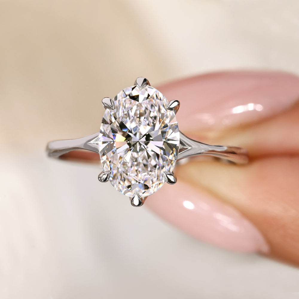 Solitaire oval diamond ring with split shank.
