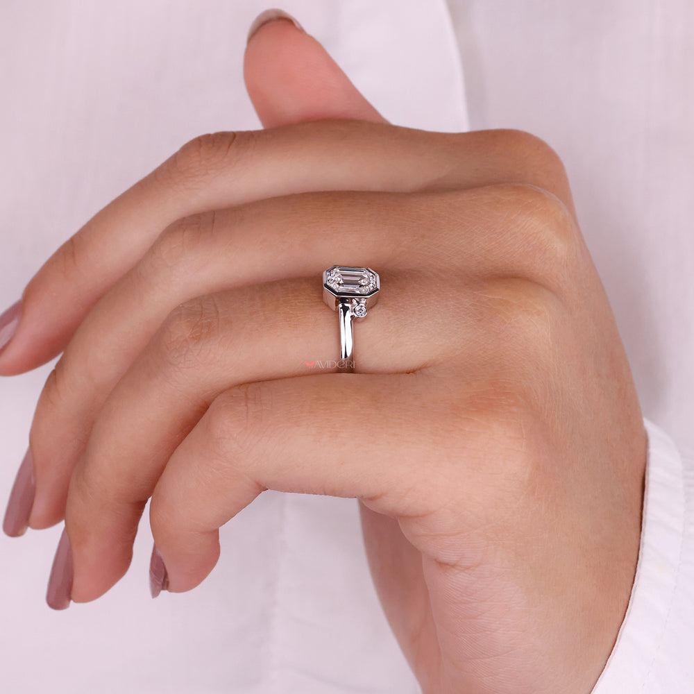 Luxurious emerald cut diamond engagement ring with sparkling accents.
