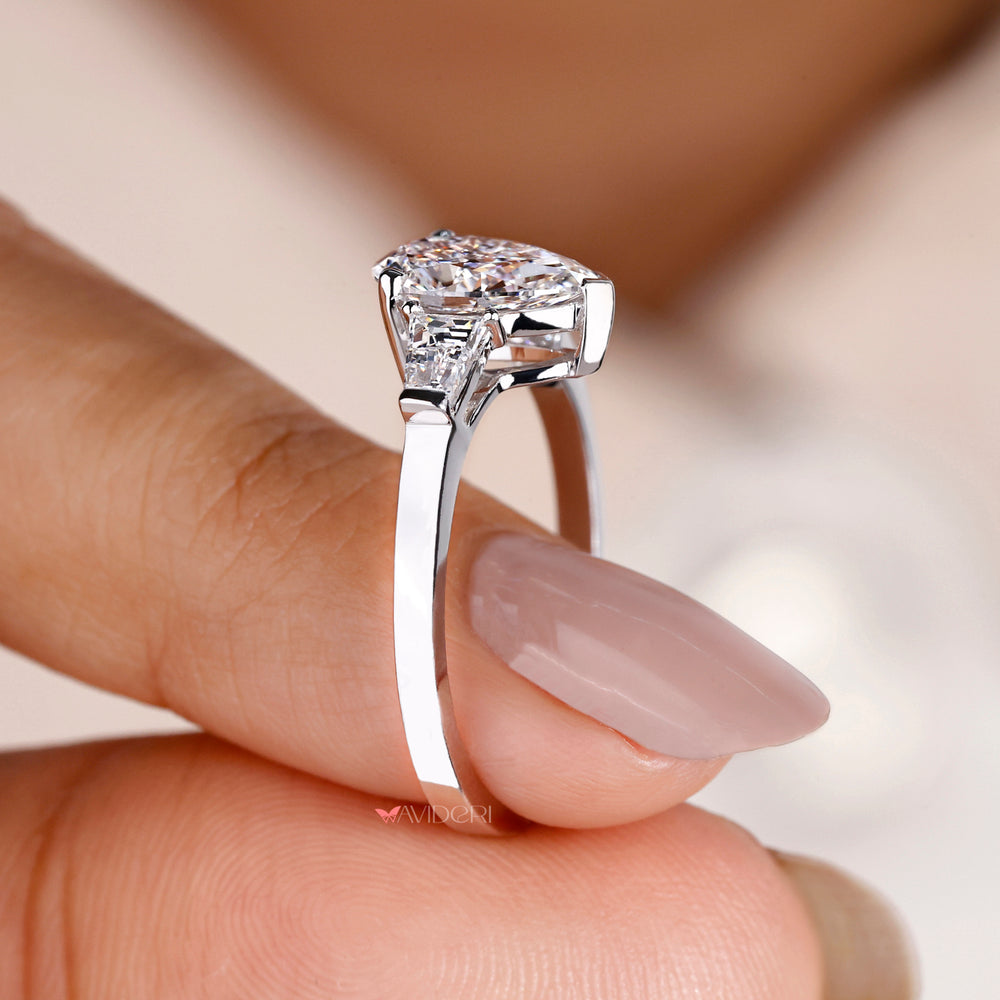2 Tapered Baguette side stone ring enhancing the beauty of the pear-shaped diamond for a luxurious finish.
