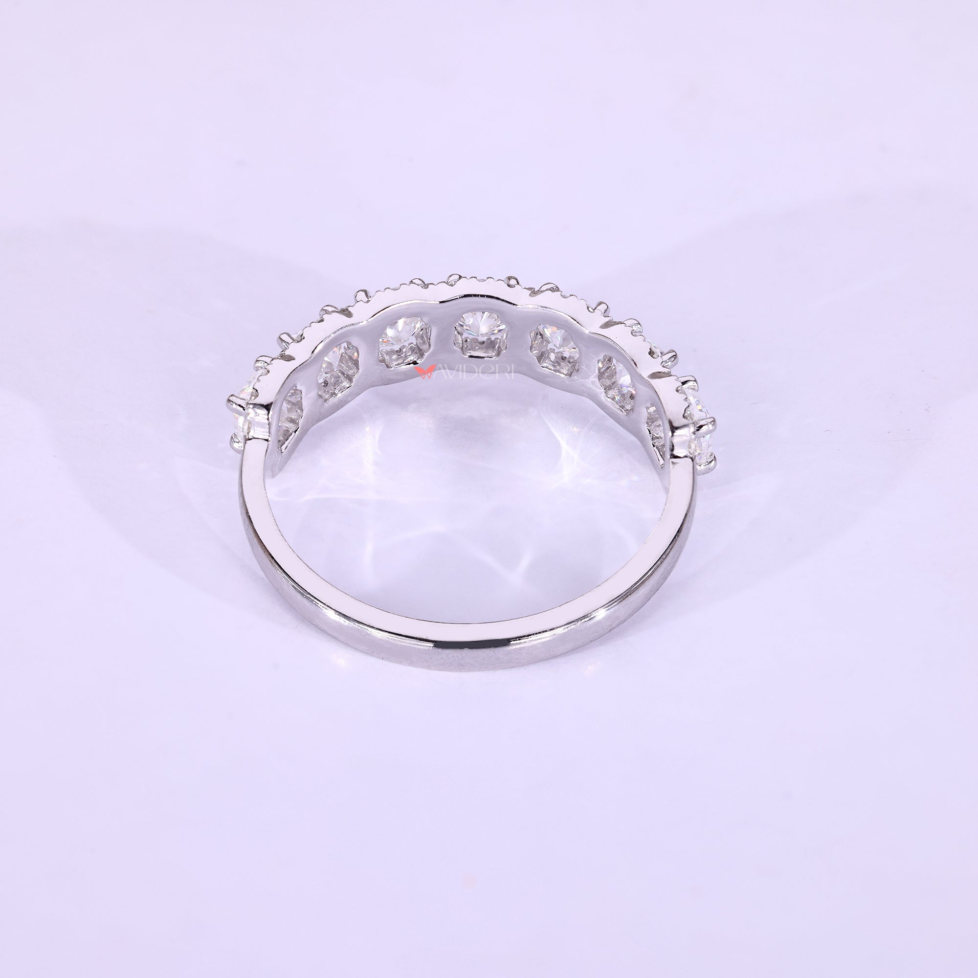 White gold wedding band with moissanite accents.