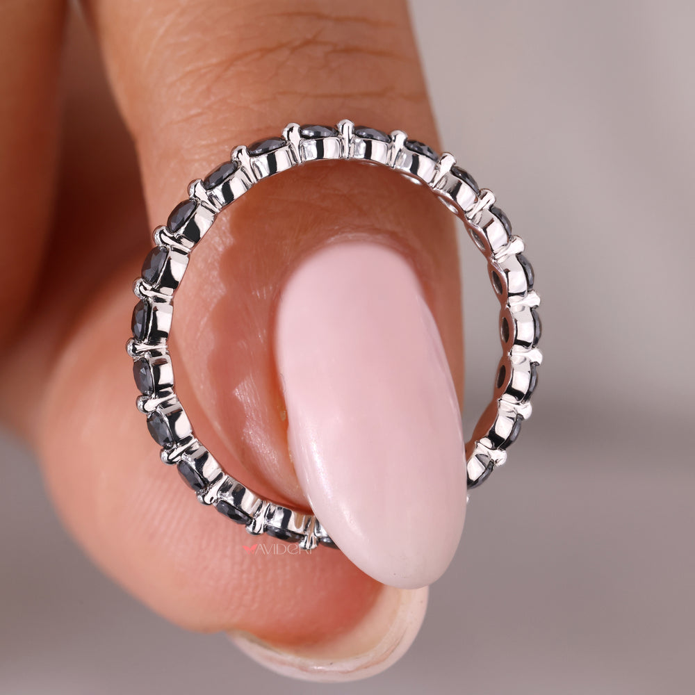 Half eternity band featuring round moissanite stones in a wedding band.