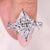 Diamond ring with intricate design on a finger