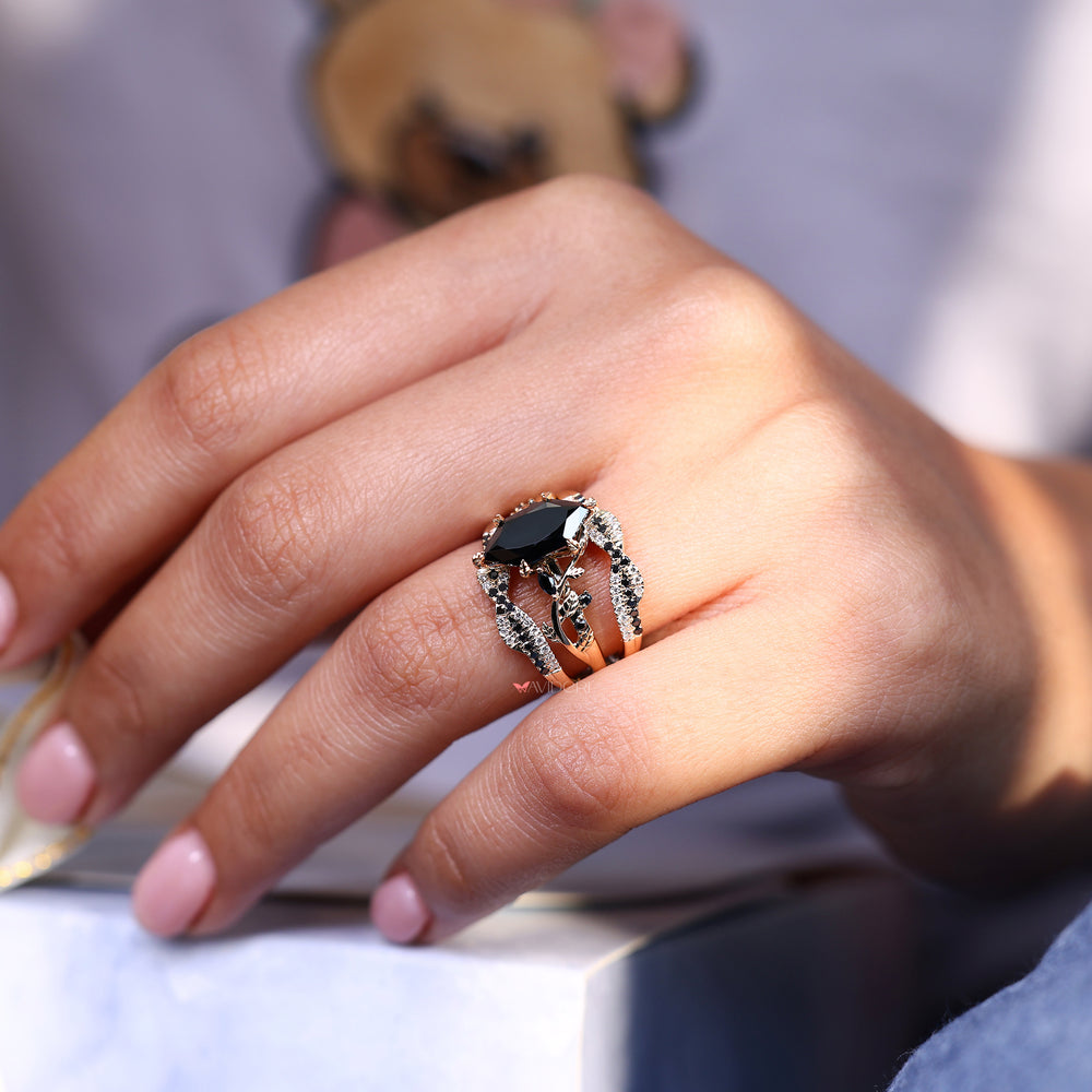 Black moissanite ring with nature inspired marquise and round design.