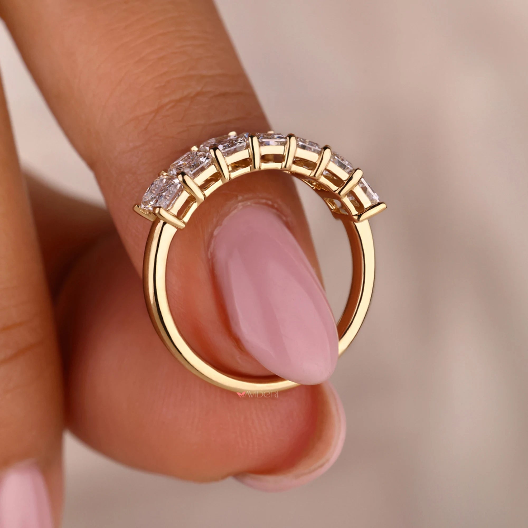 Yellow gold diamond band with prong setting.