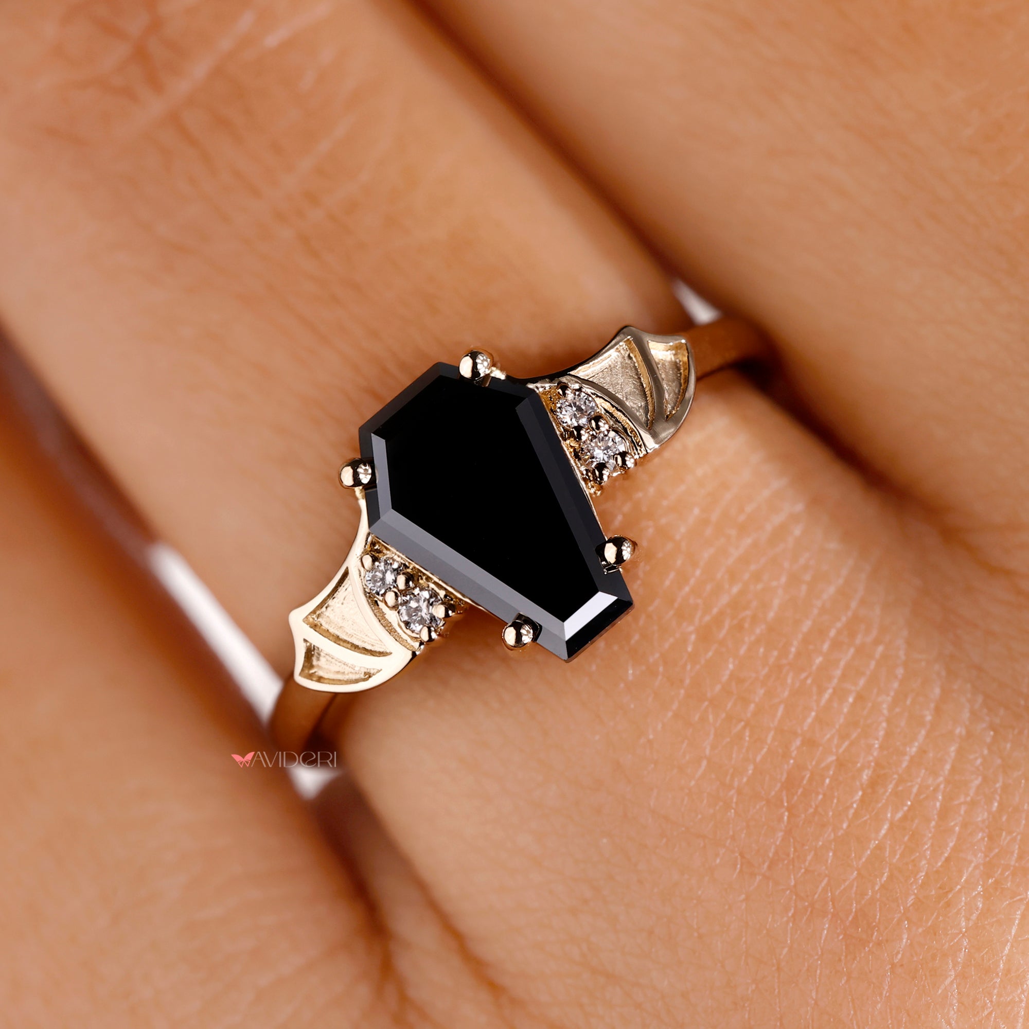 Round cut side stone with yellow gold engagement ring.