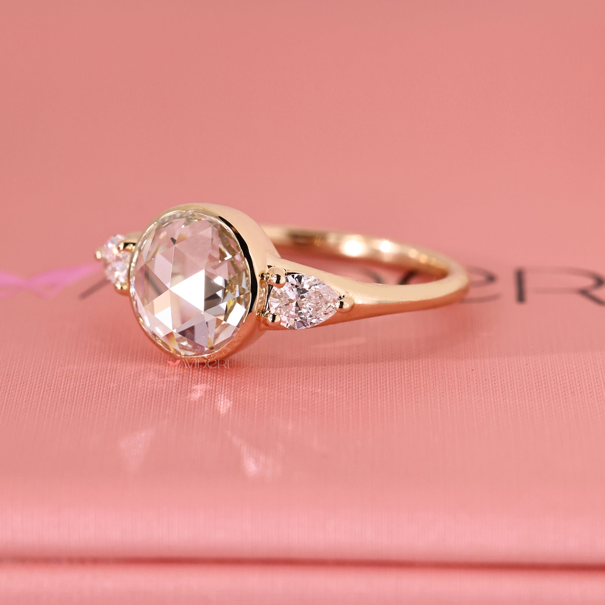 Pear cut engagement ring on yellow gold engagement ring.