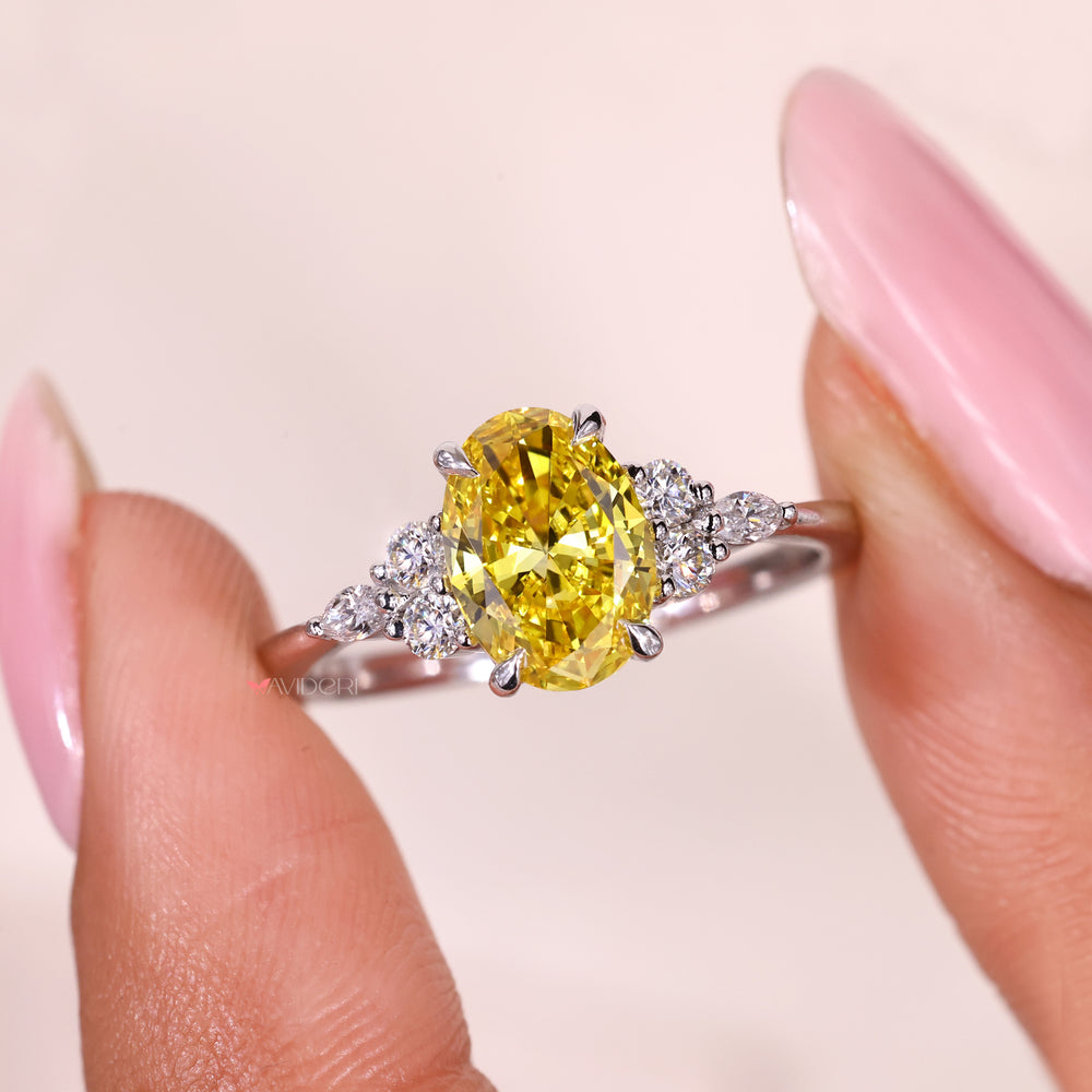 Lab grown oval yellow diamond ring with side stone detail.