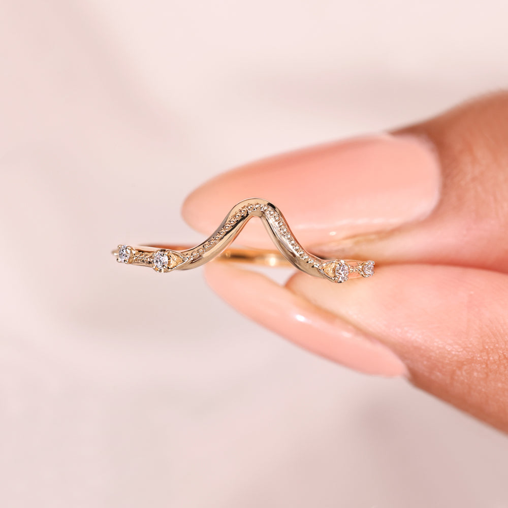 Round diamond wedding band with curved design.
