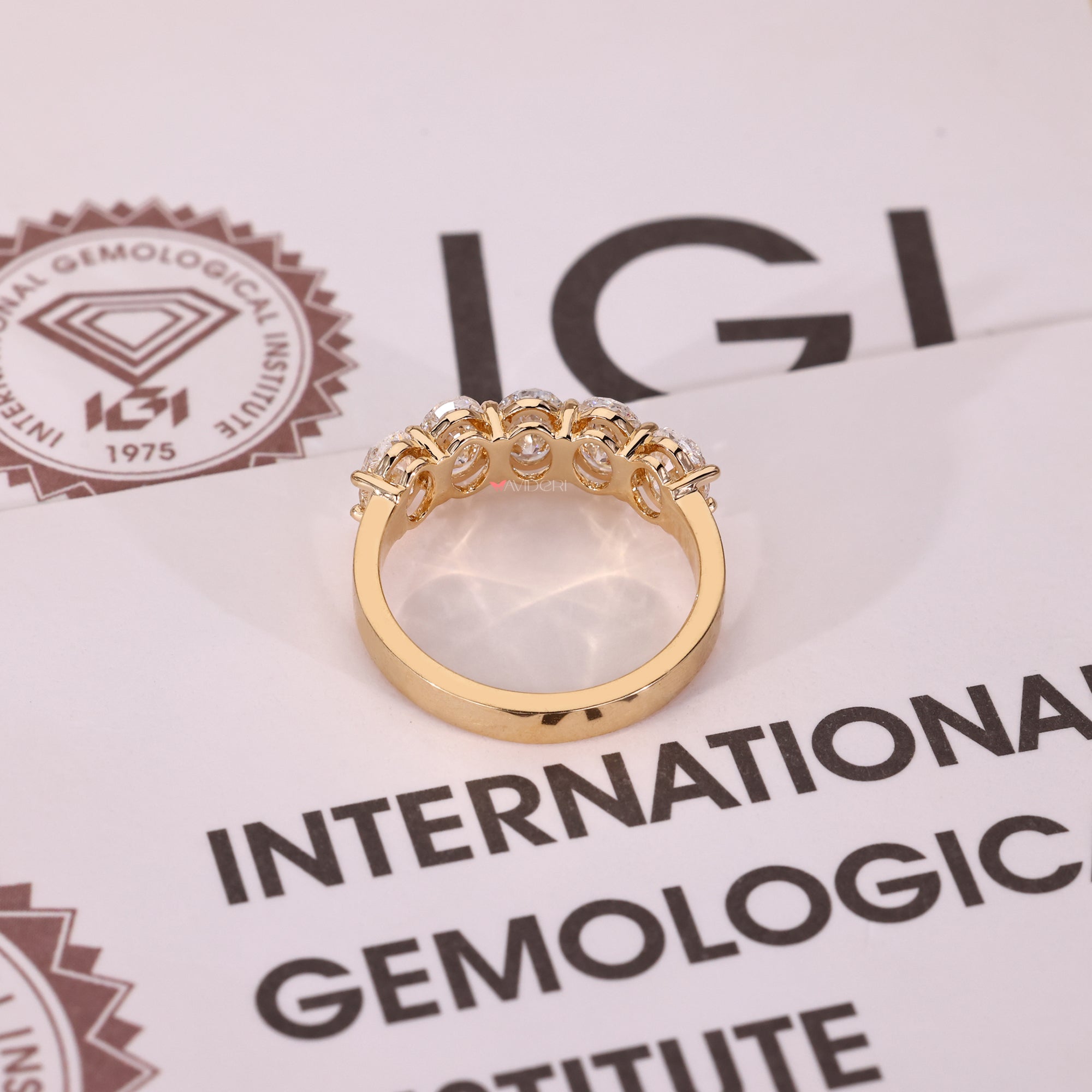 Yellow gold band with a five stone layout.