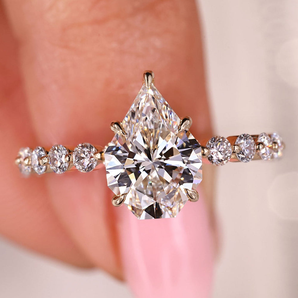 Pear step cut diamond ring with modern style.