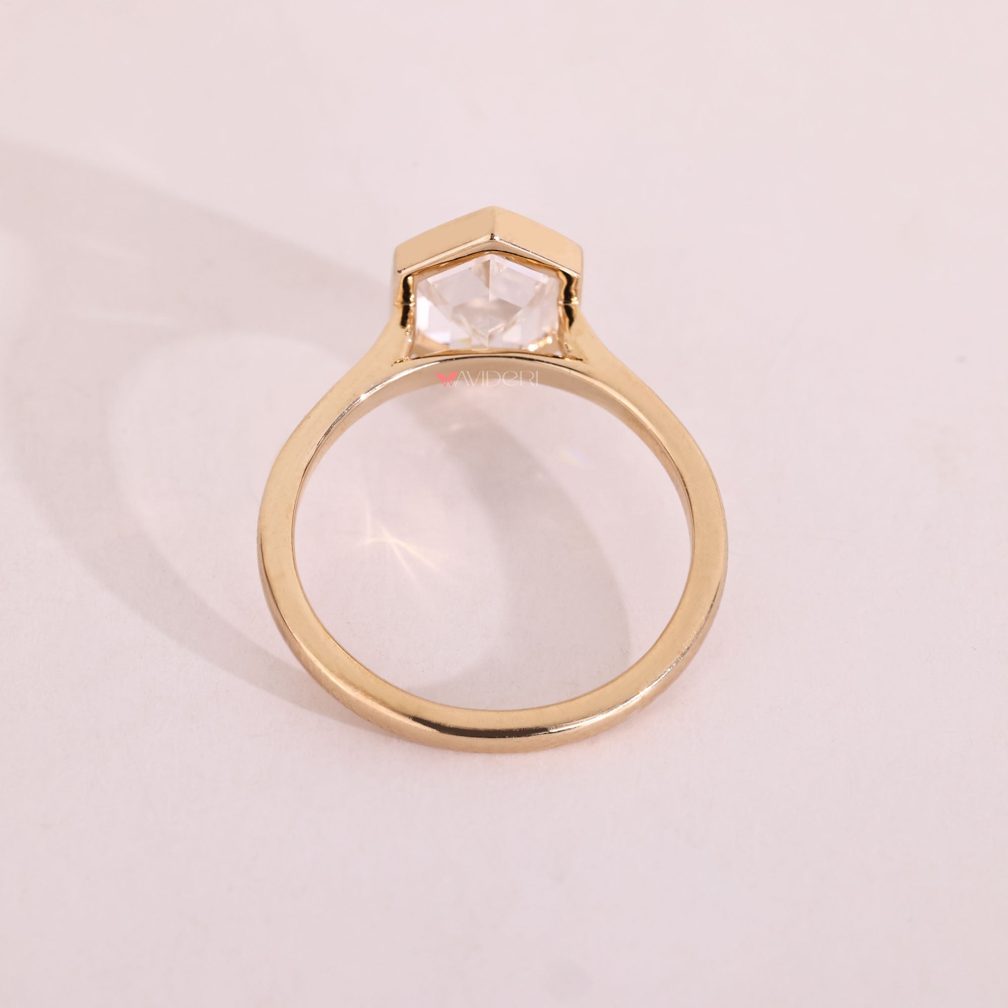 Yellow gold diamond ring in bezel solitaire style.