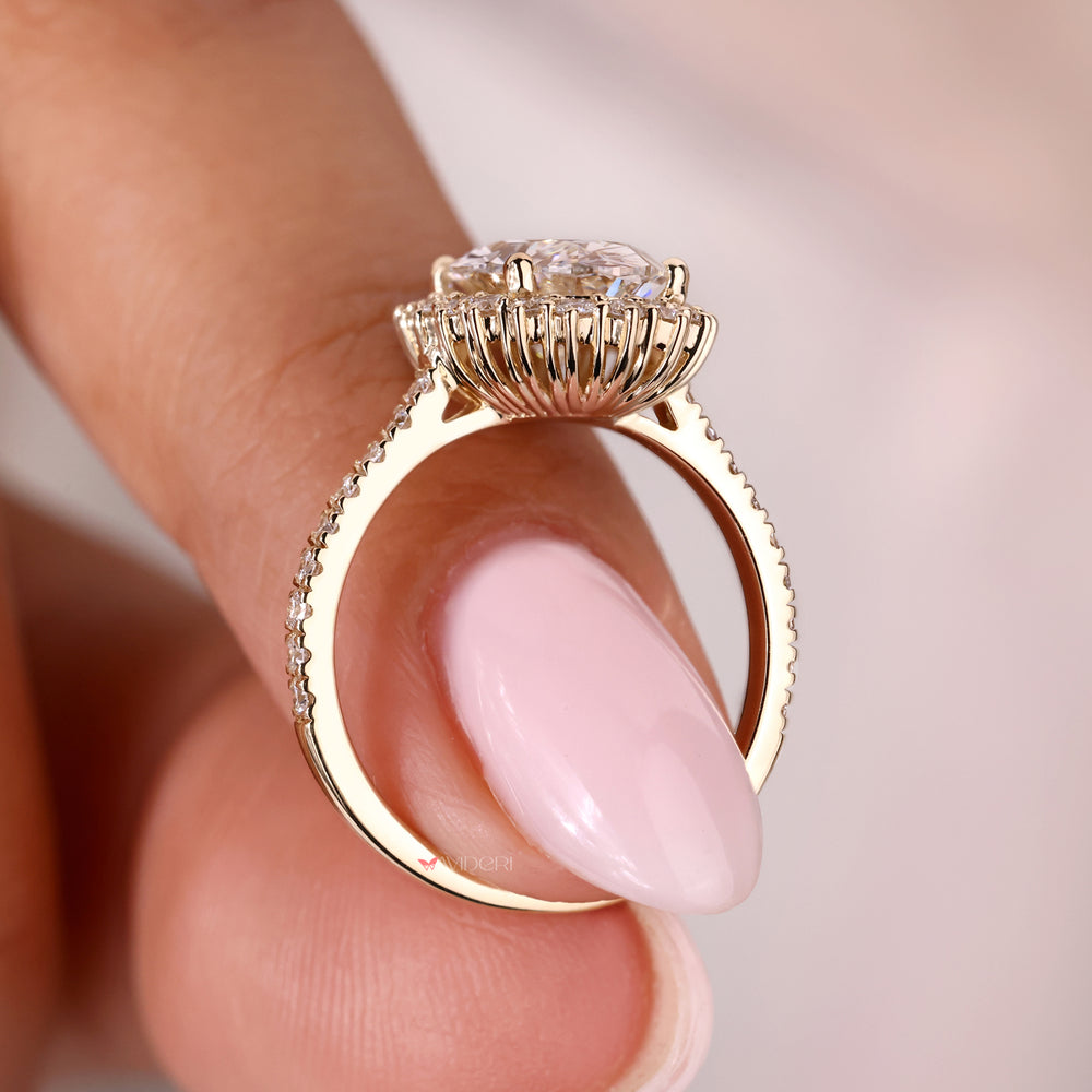 Halo diamond engagement ring with a brilliant oval diamond center.
