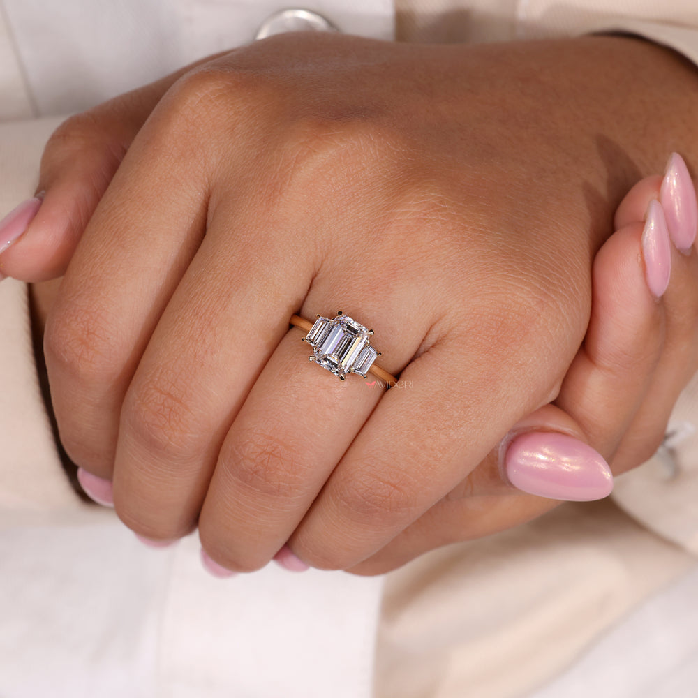 Trapezoid engagement ring featuring an emerald cut diamond for added sophistication.
