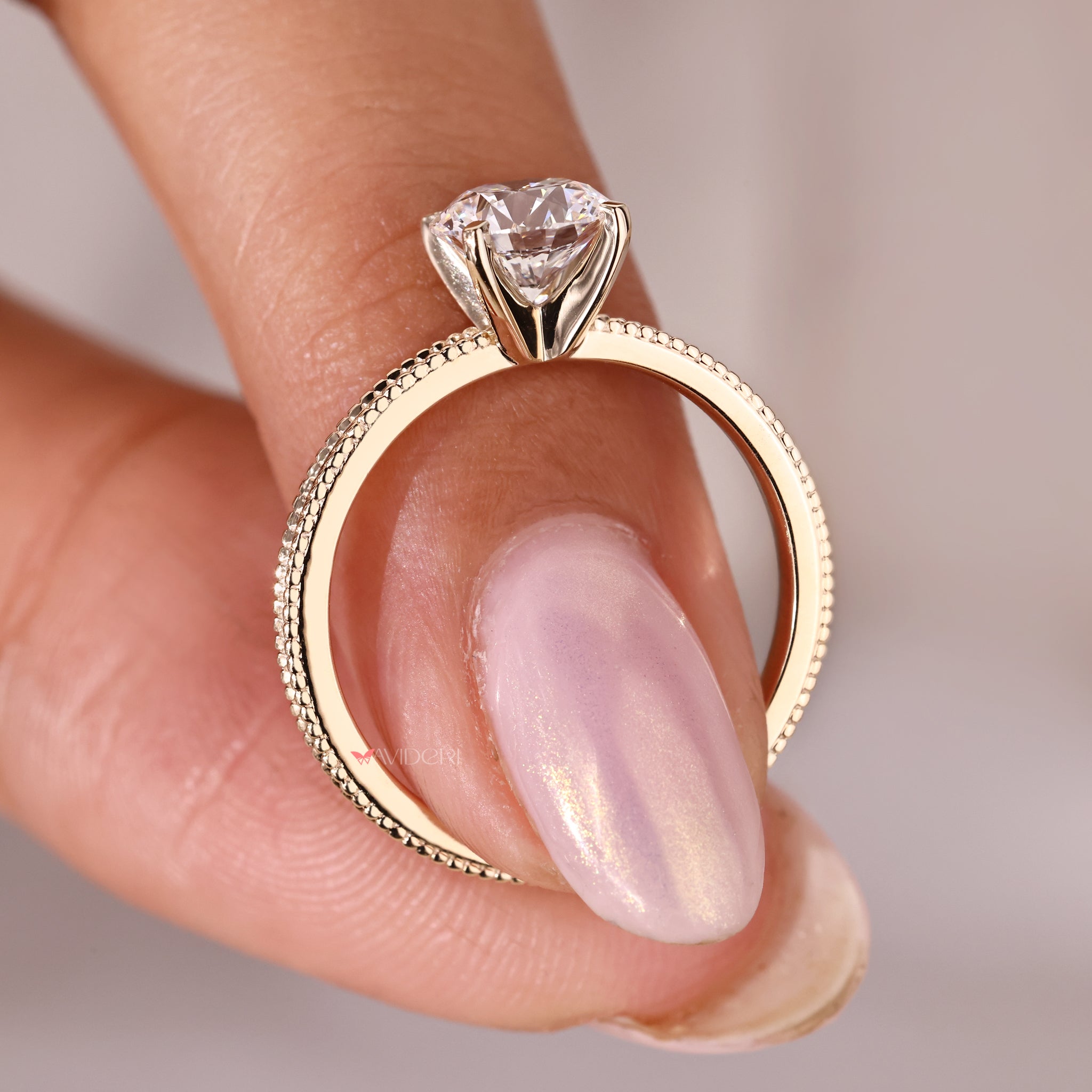 Yellow gold engagement ring with a milgrain setting.