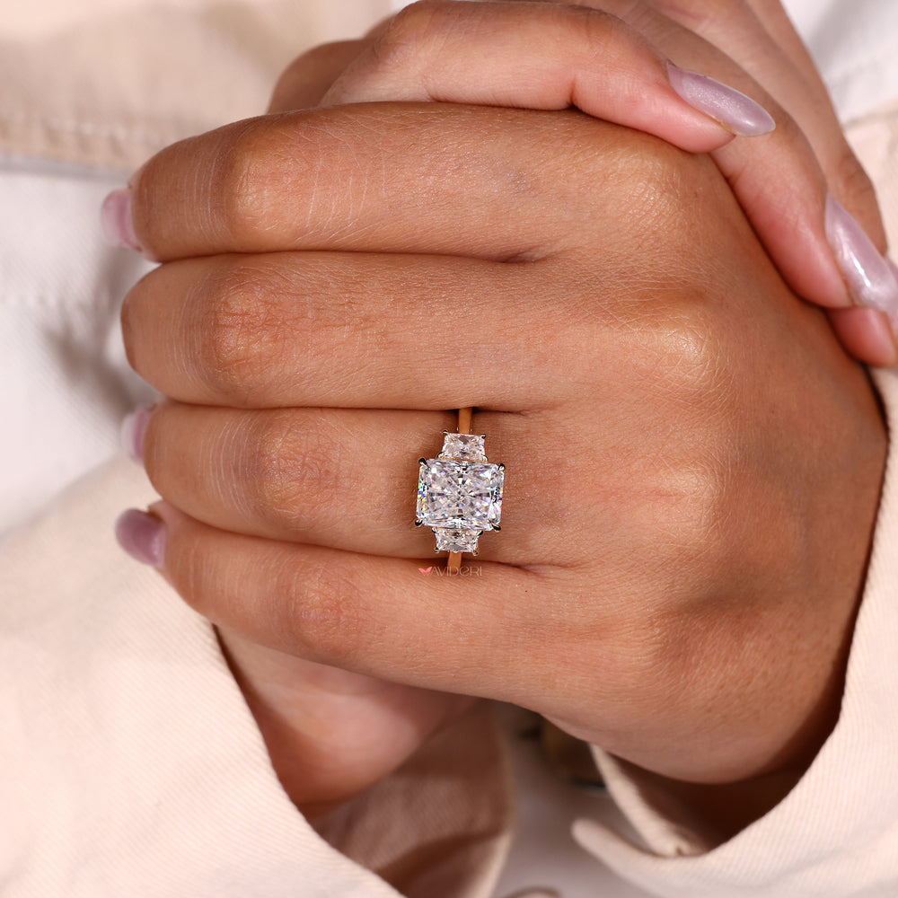 Radiant cut moissanite ring with trapezoid diamonds.

