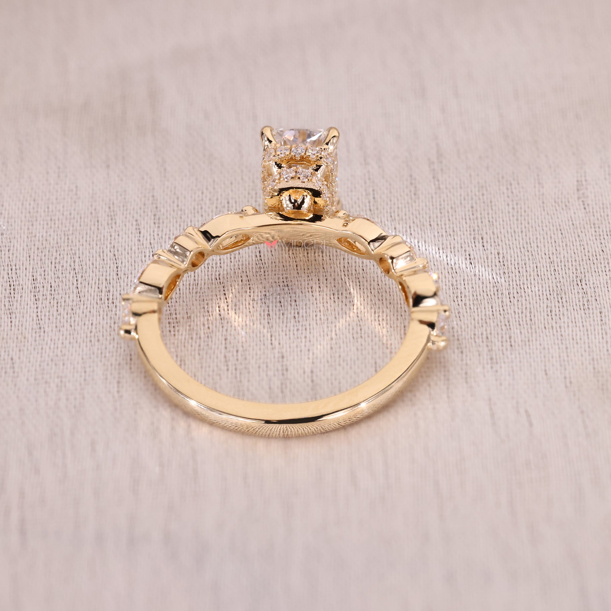 Yellow gold engagement ring with radiant cut and hidden halo.
