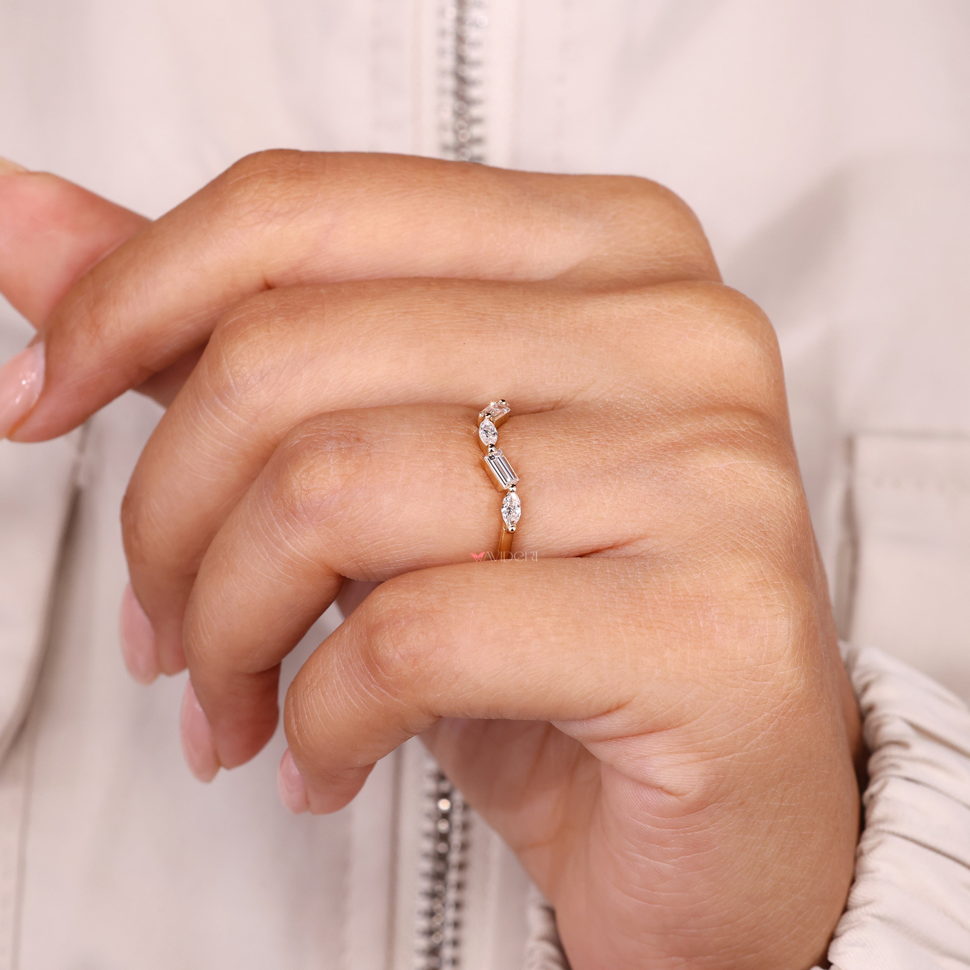 Curved diamond band with marquise and baguette cut stones.

