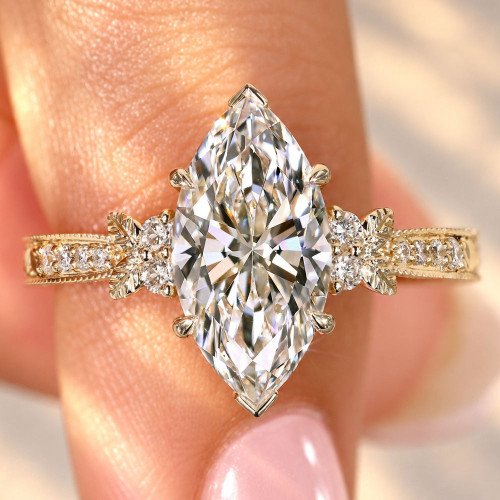 Marquise diamond ring with round side stones.
