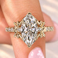 Marquise diamond ring with round diamond pave.

