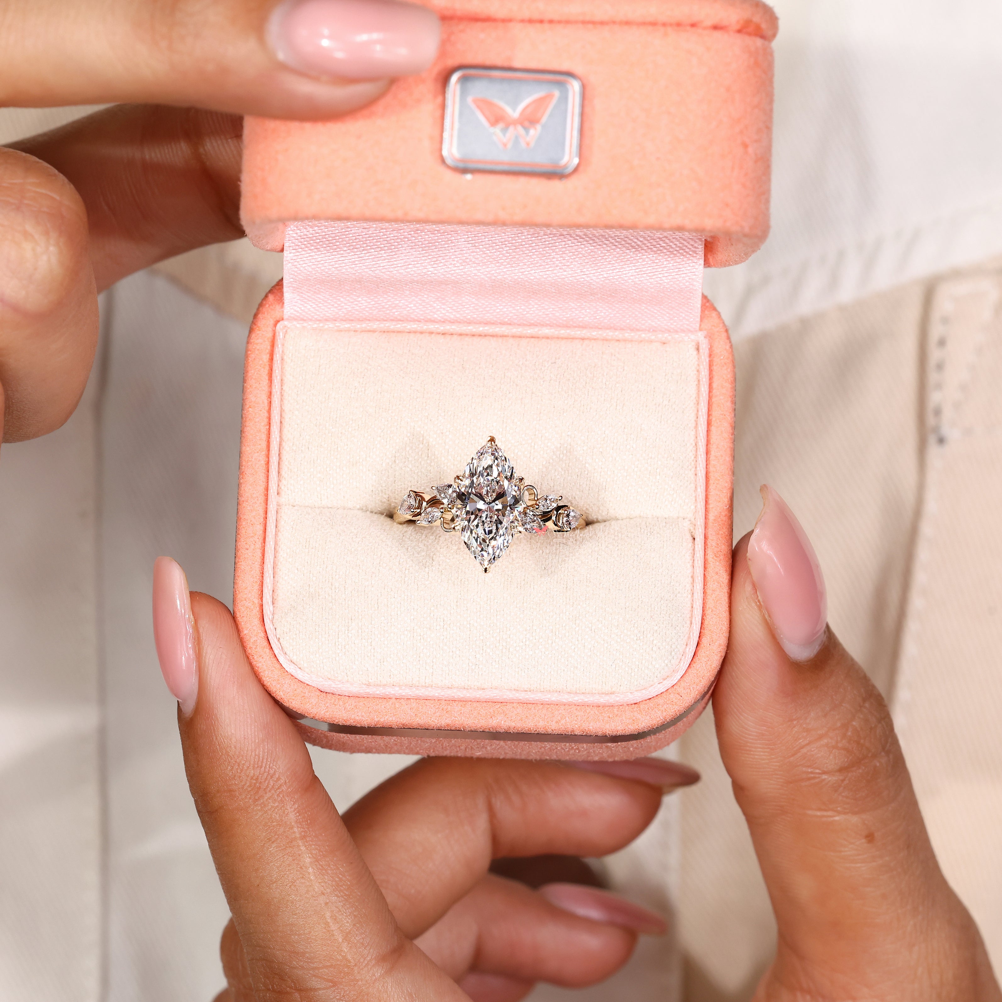 Handmade engagement ring with marquise diamond and leaf prongs
